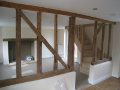 Kitchen through to living room with bespoke ash staircase and exposed original fireplace